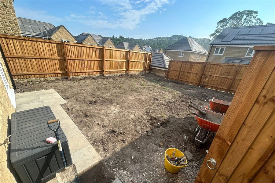 New close-board fence panels installed along a garden boundary.